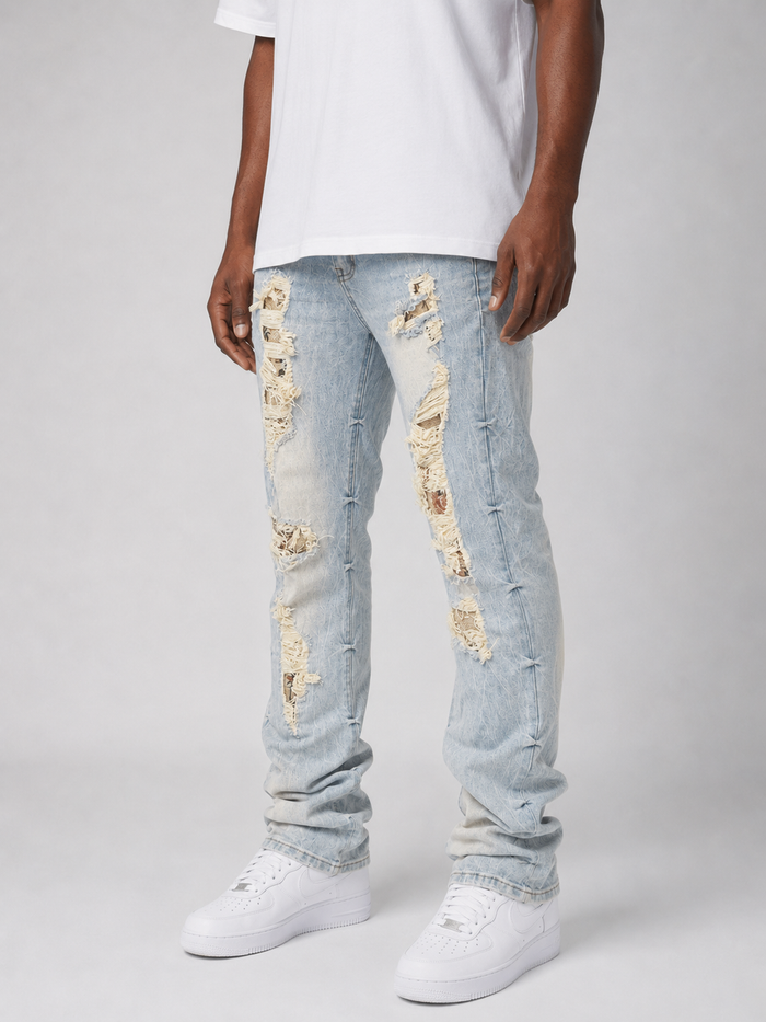 Smoke Rise Aim High tapestry applique denim stack in Seville Blue, featuring intricate stitched design and textured denim fabric.