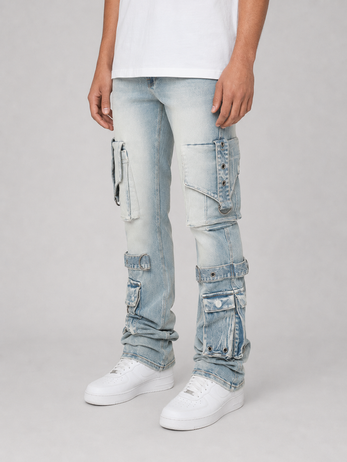 Smoke Rise stacked flare cargo jeans in Parsons Blue with eyelet details, showcasing denim texture and stylish fit.