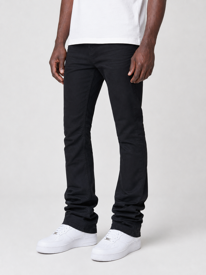 Smoke Rise vintage wash stacked flare denim jeans in jet black, showing the fitted waist and flared leg design.