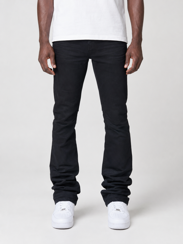 Smoke Rise vintage wash clean stacked flare denim jeans in jet black, displayed folded on a neutral background.