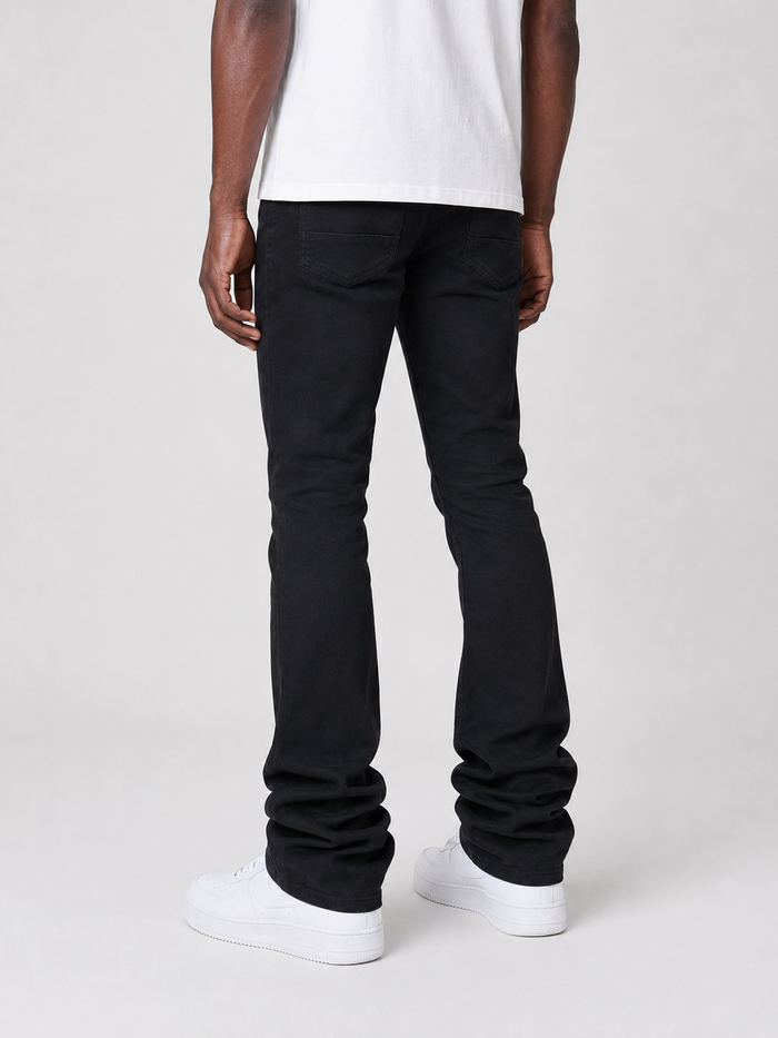 Smoke Rise vintage wash stacked flare denim in jet black, showing the fitted high-waist style and flared leg design.