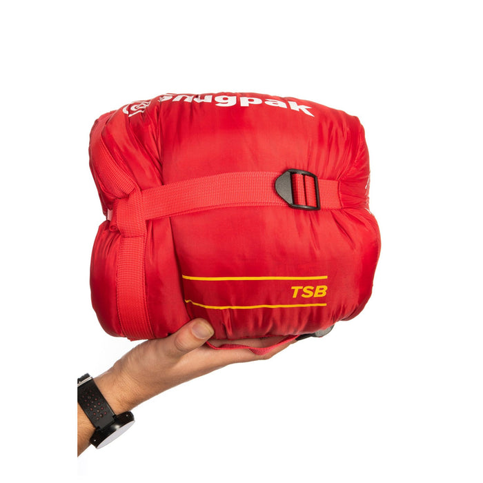 Snugpak The Sleeping Bag TSB packed and compressed in its own compression stuff sack and being held in someones hand for size comparison