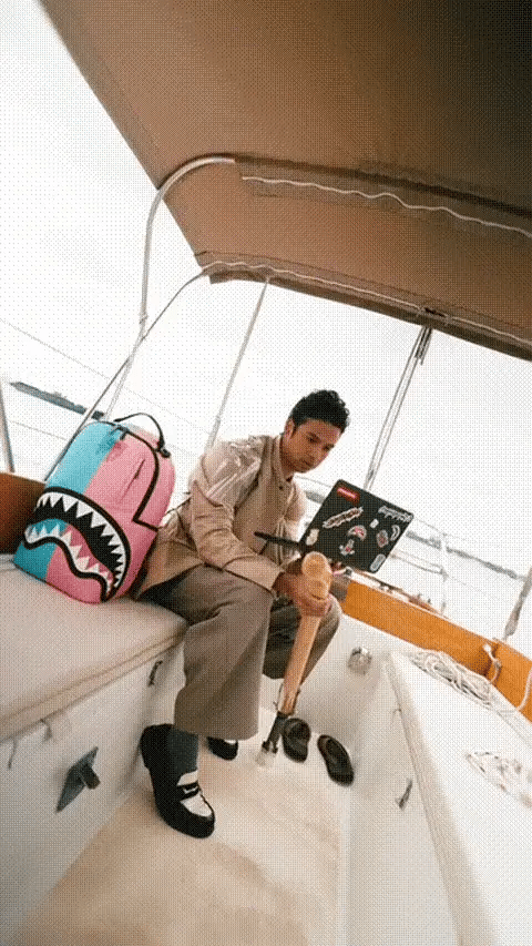 Sprayground Candy Clash Shark Central backpack featuring colorful shark and cotton candy design for accessories collection.