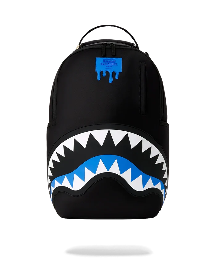 Sprayground Shark Central Passport Blue backpack with shark graphic, blue color, and adjustable straps for accessories.