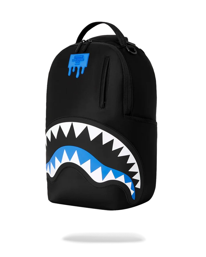Sprayground Shark Central Passport Blue backpack with shark graphic, adjustable straps, and front zipper pocket for accessories.