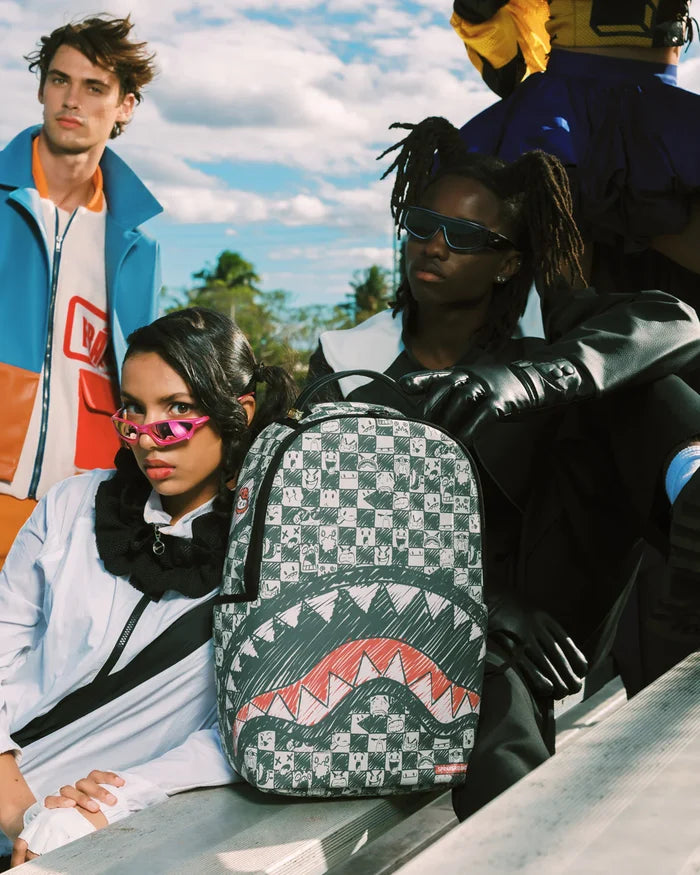 Sprayground Sharks in Paris Outlaws backpack featuring bold shark and Paris-themed graphic design on black accessories bag.