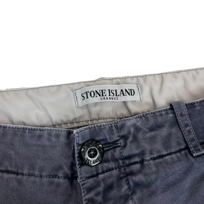 Stone Island navy blue slim fit cotton trousers with logo patch and fading details.