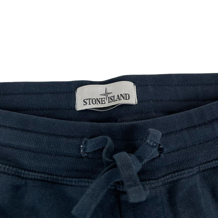 Stone Island navy blue joggers with logo patch and cotton material.