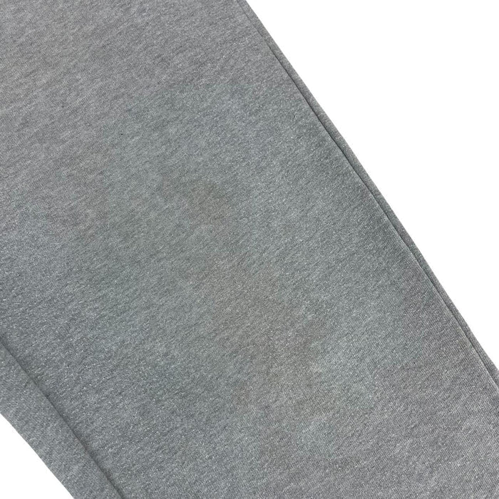 Stone Island grey tracksuit bottoms cotton material with logo patch and faint marks.