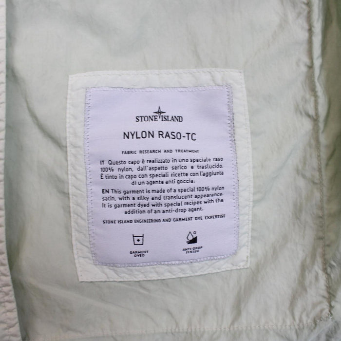 Stone Island mint green multi pocket jacket with logo patch and nylon material.