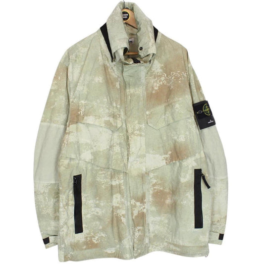 Stone Island green full zip jacket with dissolving grid camo pattern and logo patch.