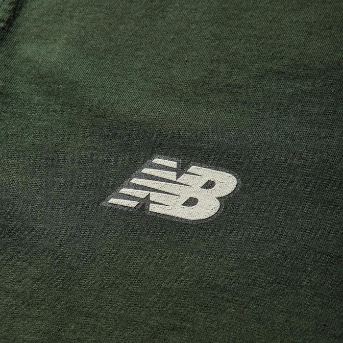 Stone Island green pocket t-shirt with embroidered crest and New Balance logo.