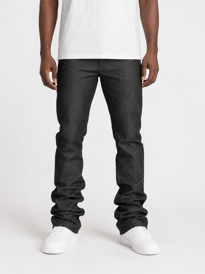 Taker Raw Fabric Stack Denim in Raw Black, close-up of dark denim fabric with visible stitching and texture.