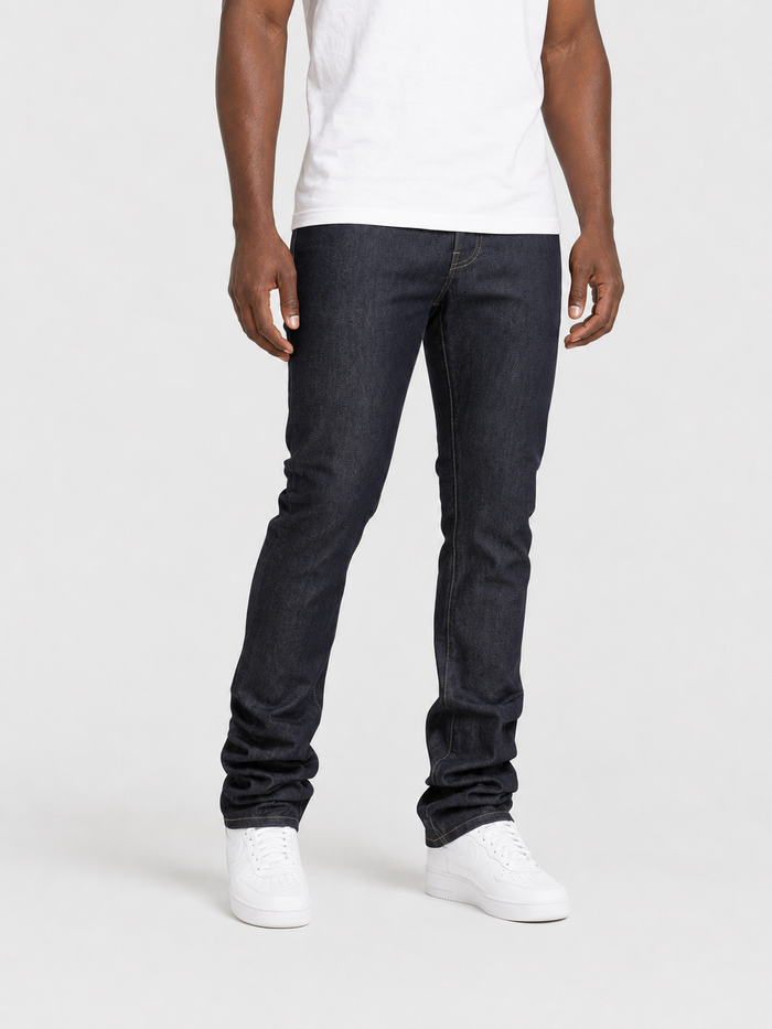 Taker Raw Fabric Stack Denim in raw indigo, showcasing folded denim fabric with a textured, raw denim appearance.