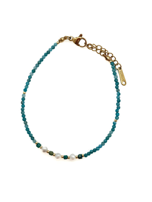 Tessa Apatite and Miyuki Bead Bracelet with blue-green apatite beads, pearl center detail, and stainless steel clasp and extender on white background.