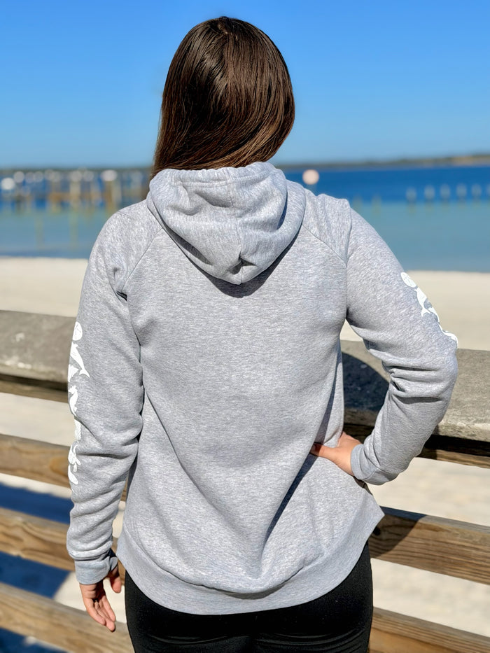 Person wearing a gray hoodie with a scenic background