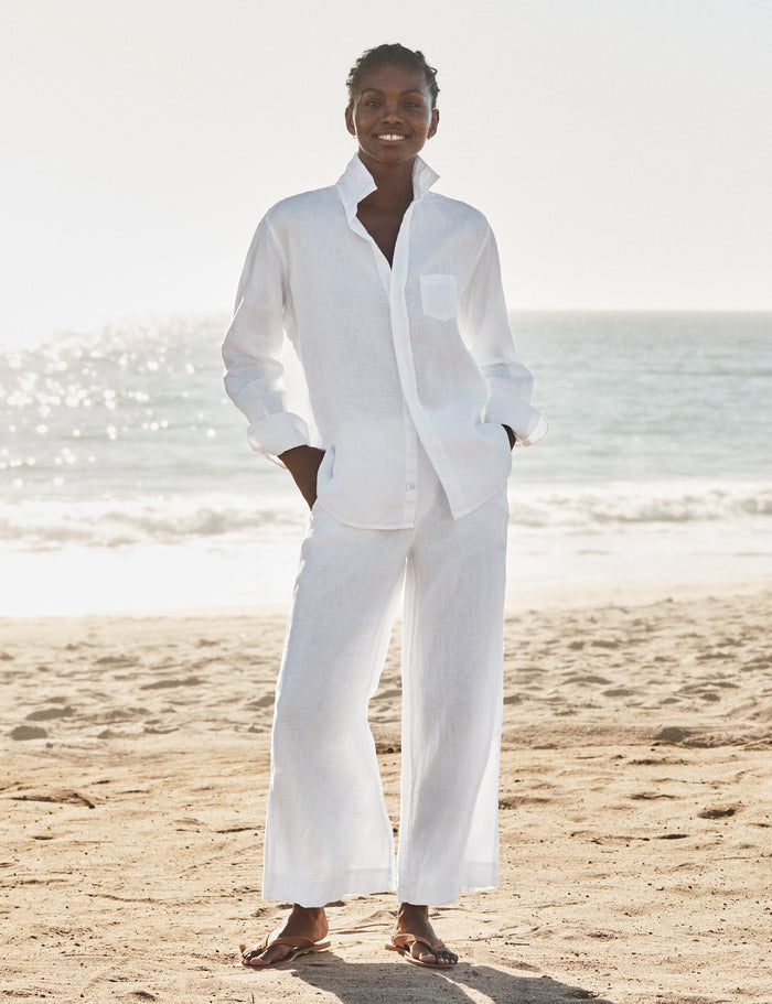 Person wearing a white outfit on a beach