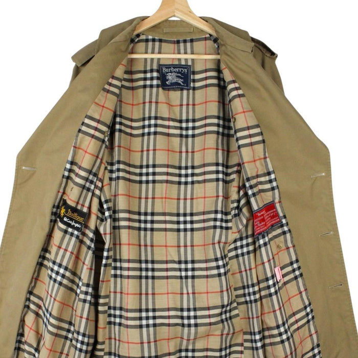 Burberry brown double breasted belted trench coat with classic check lining and logo details.