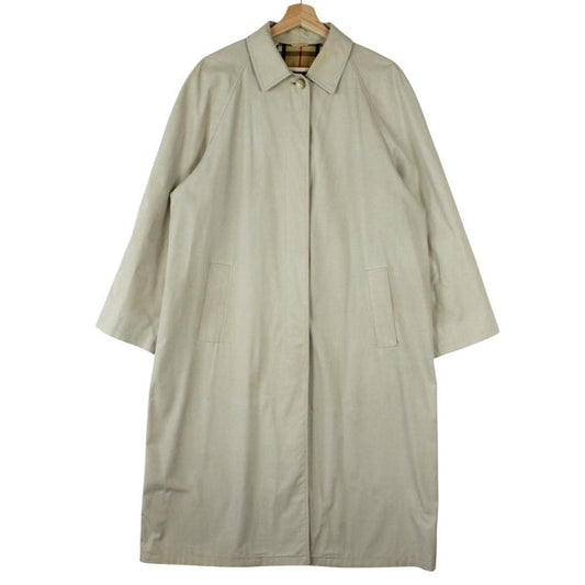 Burberry beige trench coat featuring iconic Nova Check pattern and single breasted design.