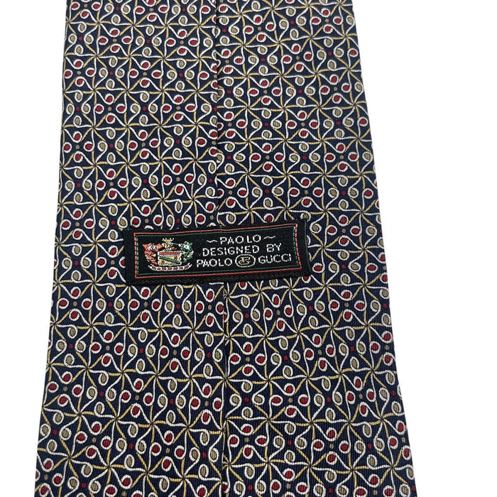 Gucci navy blue silk tie with vintage pattern and logo detail.