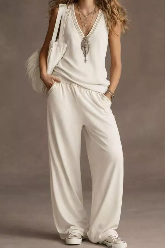 Woman wearing a white outfit with a plain background