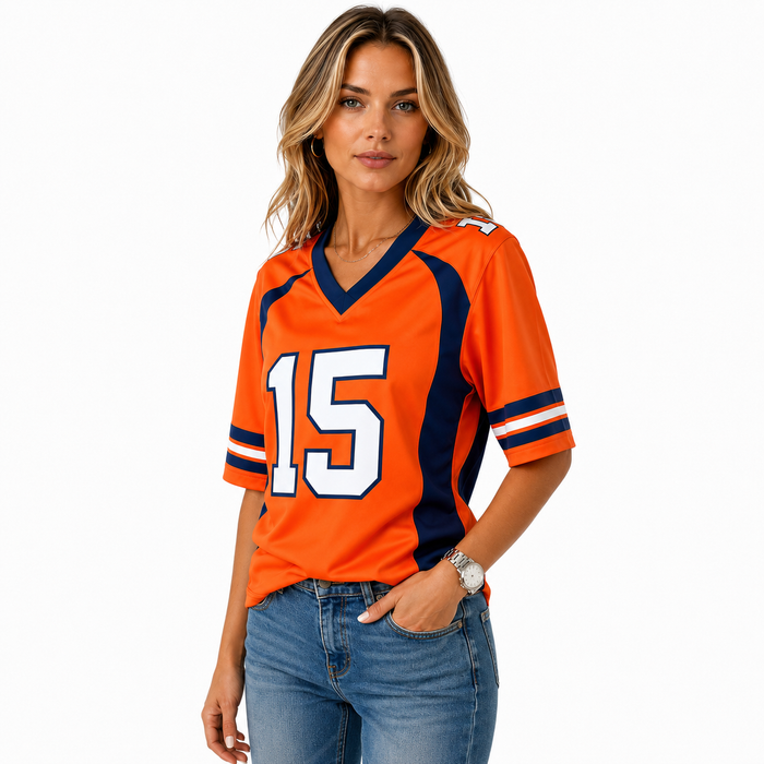 Model wearing orange number 15 jersey top with relaxed fit and clean sporty styling