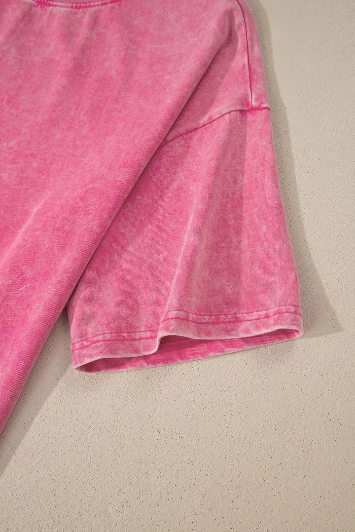 Close-up of a pink fabric item on a beige surface