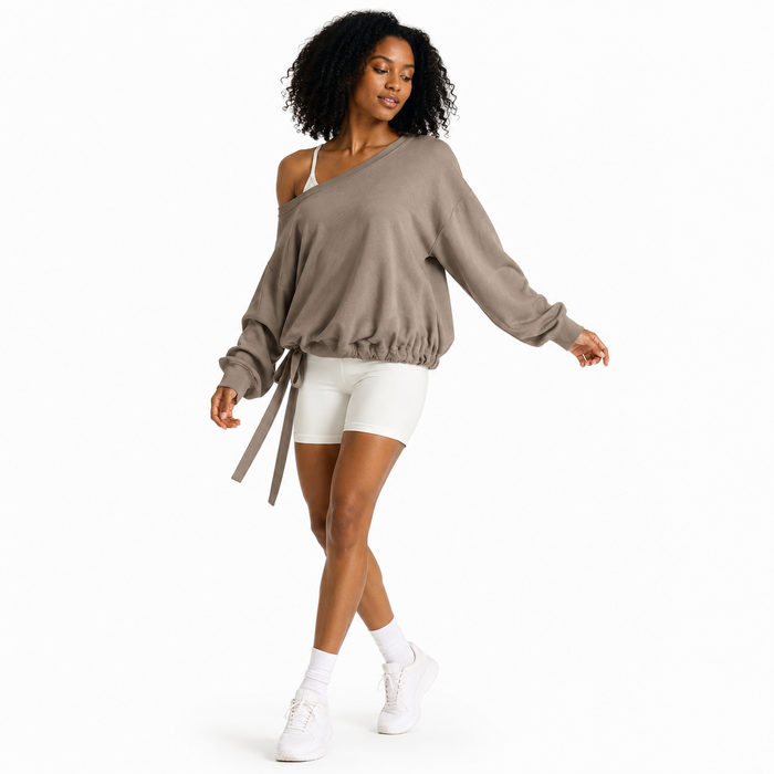 Women's loose fit pullover hoodie in khaki, natural movement studio view