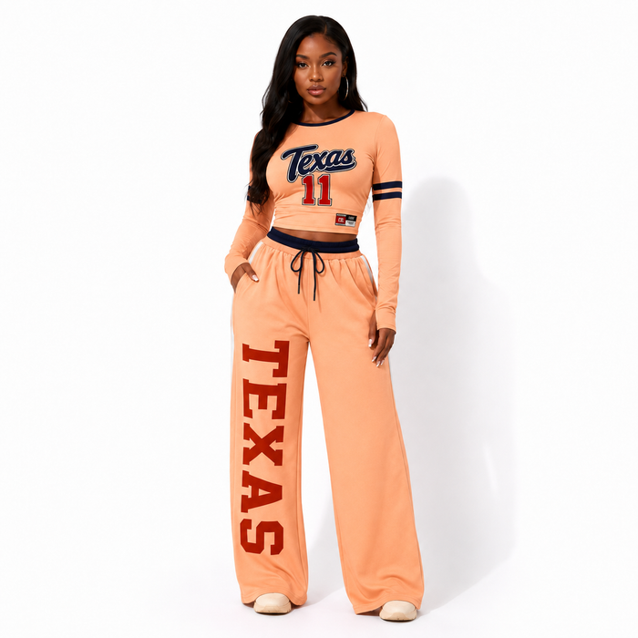 Nude-to-orange gradient women's two piece set in a front view showing the cropped top, wide-leg pants, and coordinated design