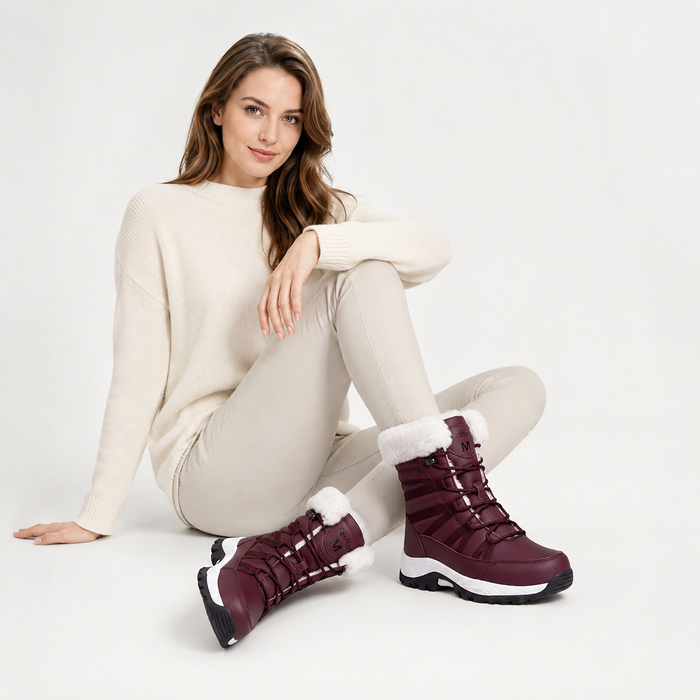 Women's burgundy fleece lined mid-calf boots shown in a lifestyle view with lace-up fronts and relaxed winter outfit styling.