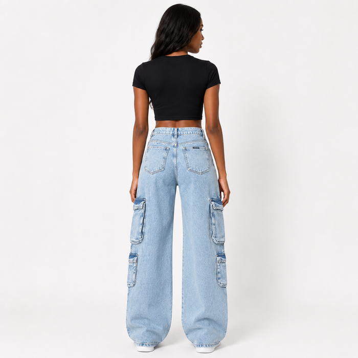 A model shown from the back wearing light-wash wide-leg cargo jeans and a black crop top against a plain white studio background.